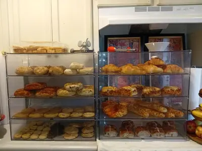 a display case filled with lots of different types of pastries at Comfy Sleep In Fraser Valley With Breakfast in Abbotsford