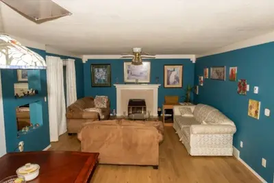 a living room with a couch and a fireplace at Comfy Sleep In Fraser Valley With Breakfast in Abbotsford