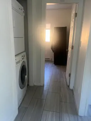 a laundry room with a washer and dryer at three bedroom near uvic in Victoria