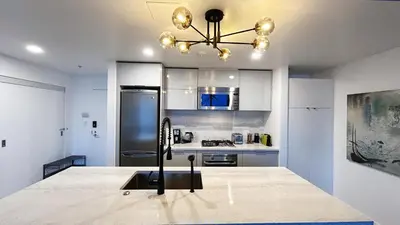 a kitchen with a refrigerator and a counter top at The Ocean Crest in Vancouver