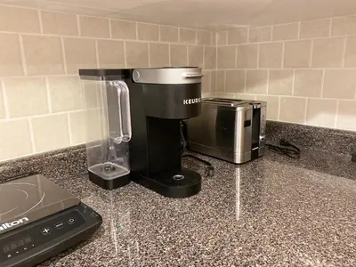 a kitchen counter with a blender and a toaster at Bright 1-Bedroom Garden Suite, Sleeps 4, Near Downtown & YVR in Vancouver