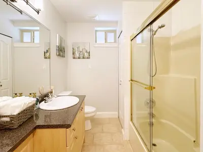 a bathroom with a sink and a shower at Bright 1-Bedroom Garden Suite, Sleeps 4, Near Downtown & YVR in Vancouver