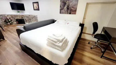 a bedroom with a bed with two white towels on it at 4th Street Studio By Downtown and Airport in Calgary