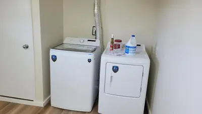 a laundry room with a washer and a dryer at 4th Street Studio By Downtown and Airport in Calgary