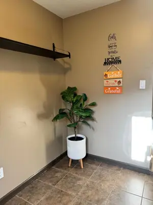 a plant in a room with a sign on the wall at Peaceful House with Backyard in Langley