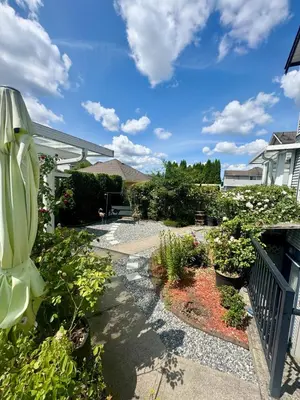a garden with flowers and plants on a patio at Peaceful House with Backyard in Langley