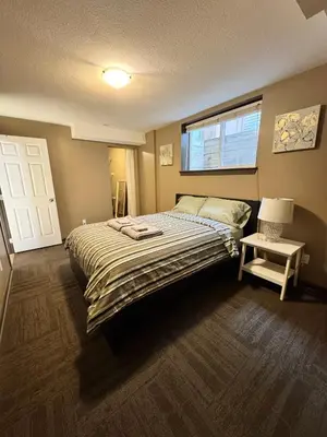a bedroom with a large bed and a window at Peaceful House with Backyard in Langley