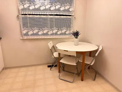 a table and chairs in a room with a window at Lavender house in Richmond