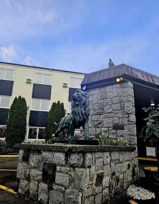 a statue of a lion in front of a building at Marina Hotel in Port Alberni