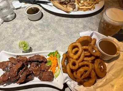 a table with two plates of food with onion rings at Marina Hotel in Port Alberni