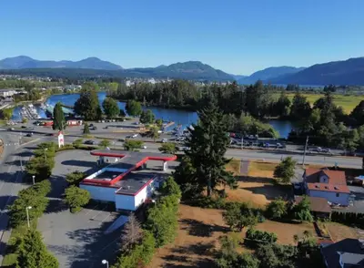 an aerial view of a park with a river and a train at Marina Hotel in Port Alberni
