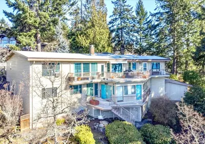 an aerial view of a large white house with trees at Departure view in Nanaimo
