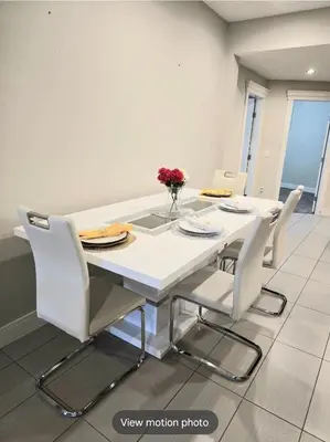 a dining room with a white table and chairs at Golden Acreage Getaway 2 Bedroom in Balzac