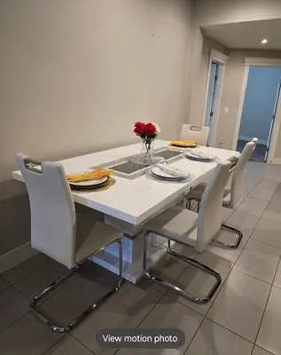 a white dining room table with white chairs and a white table and chairsktop at Golden Acreage Getaway 2 Bedroom in Balzac