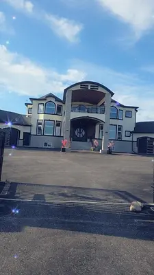 a large building in front of a parking lot at Golden Acreage Getaway 2 Bedroom in Balzac