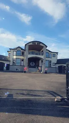 a large building in front of a parking lot at Golden Acreage Getaway 2 Bedroom in Balzac