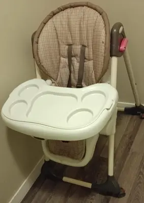 a childs high chair sitting in a room at Private & Beautifully Finished Suite, Windermere in Edmonton