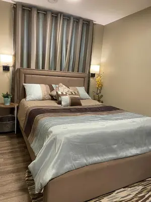 a bedroom with a large bed with a headboard at Private & Beautifully Finished Suite, Windermere in Edmonton