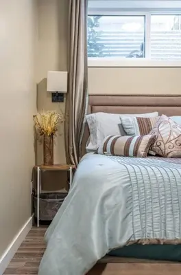 a bedroom with a bed with a window and a bed sidx sidx sidx at Beautifully Finished Basement Suite, Shared Entrance, SW Edmonton in Edmonton