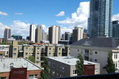 a view of a city skyline with tall buildings at Elevated Living: 2-Bedroom Upper Apartment in Calgary