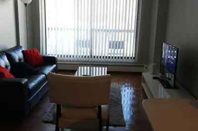 a living room with a couch and a tv at Elevated Living: 2-Bedroom Upper Apartment in Calgary
