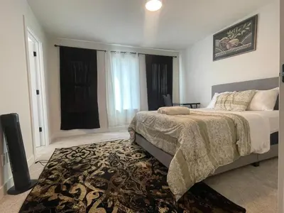a bedroom with a large bed and a rug at Bedroom private Bathroom in Upland in Edmonton