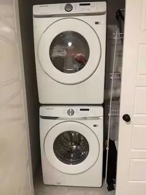 a washing machine and a dryer in a room at Bedroom private Bathroom in Upland in Edmonton