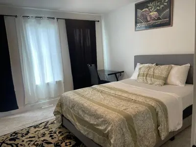 a bedroom with a bed and a window at Bedroom private Bathroom in Upland in Edmonton