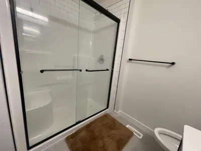 a shower with a glass door in a bathroom at Bedroom private Bathroom in Upland in Edmonton