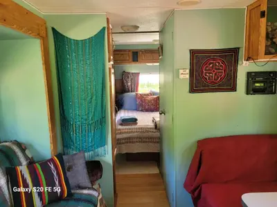 a small room with a bedroom and a small room with a bed at Rara's secret nest in Aiyansh