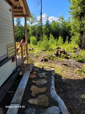 a dog sitting on the porch of a house at Rara's secret nest in Aiyansh