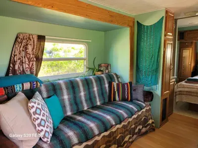 a living room with a couch and a window at Rara's secret nest in Aiyansh