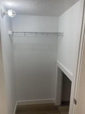 a white room with a shelf on the wall at Westminister Manor in Calgary