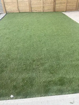 a yard of green grass next to a fence at Westminister Manor in Calgary