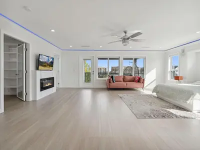 a white bedroom with a bed and a couch at Spacious 4BR Langley Home in Langley