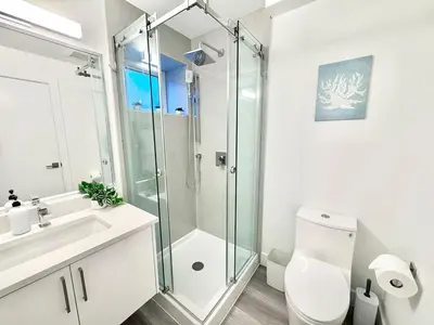 a bathroom with a shower and a toilet and a sink at Perfect Vancouver Travel Hub for Couples or Family in Vancouver