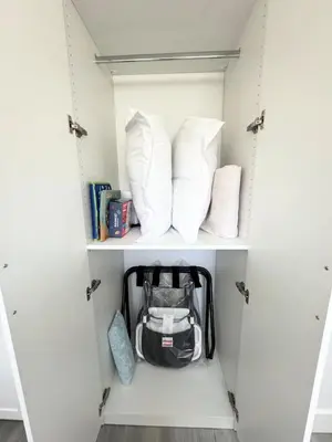 a white cabinet with pillows and a bag in it at Perfect Vancouver Travel Hub for Couples or Family in Vancouver