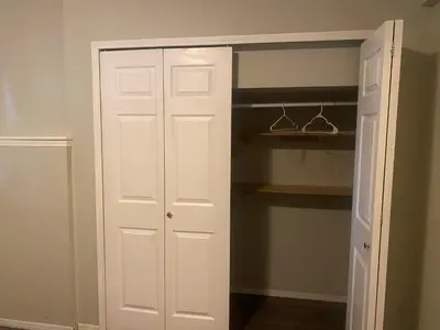 a closet with a white door and shelves at Basement Appartment in Edmonton