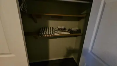a small closet with some towels on a shelf at Basement Appartment in Edmonton