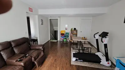 a living room with a couch and a table at Basement Appartment in Edmonton