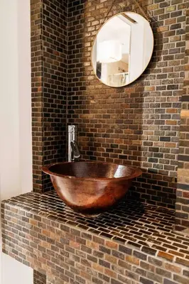 a wooden bowl on a brick wall with a mirror at 4 Bed Home Along River Near DT AC Hot Tub in Calgary