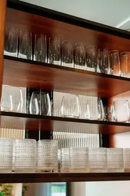 a bunch of glasses sitting on a shelf at 4 Bed Home Along River Near DT AC Hot Tub in Calgary