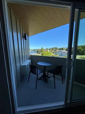 a balcony with a table and chairs and a view at Hotel 19 in Port Hardy