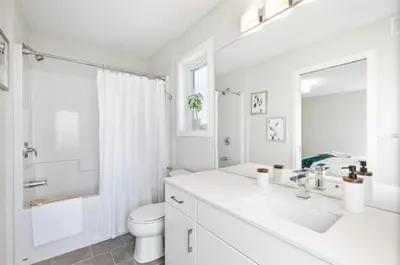 a white bathroom with a sink and a toilet at Magnificent Stylish Escape in Bélanger