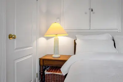 a bedroom with two beds and a lamp on a table at Garden Suite near Jericho Beach in Vancouver