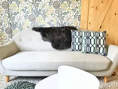a dog sitting on a couch in a living room at Top Floor Mountain View Escape in Canmore