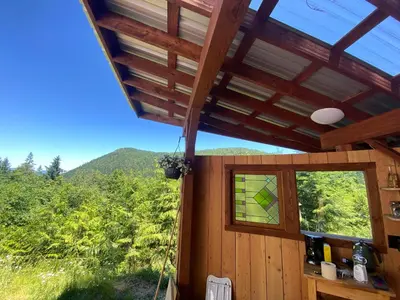 a view from inside a cabin with a window at Tree Top Sanctuary Cowichan Valley in Duncan