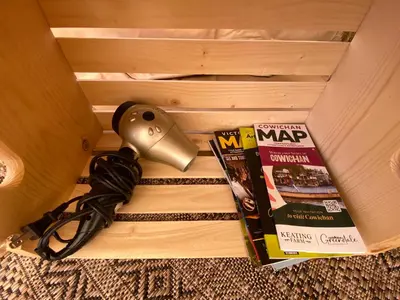 a box with a camera and magazines on it at Tree Top Sanctuary Cowichan Valley in Duncan