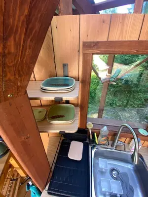 a kitchen with a sink and a counter with a window at Tree Top Sanctuary Cowichan Valley in Duncan