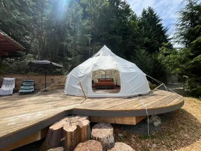 a white tent sitting on a wooden deck at Tree Top Sanctuary Cowichan Valley in Duncan